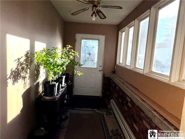 entryway featuring ceiling fan and a baseboard heating unit