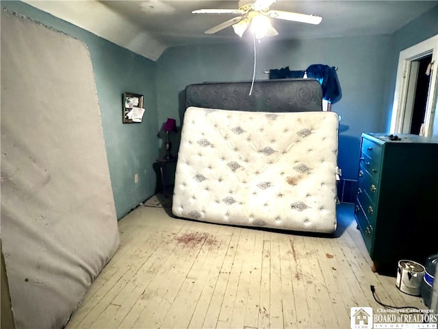 bedroom featuring light hardwood / wood-style flooring, ceiling fan, and lofted ceiling