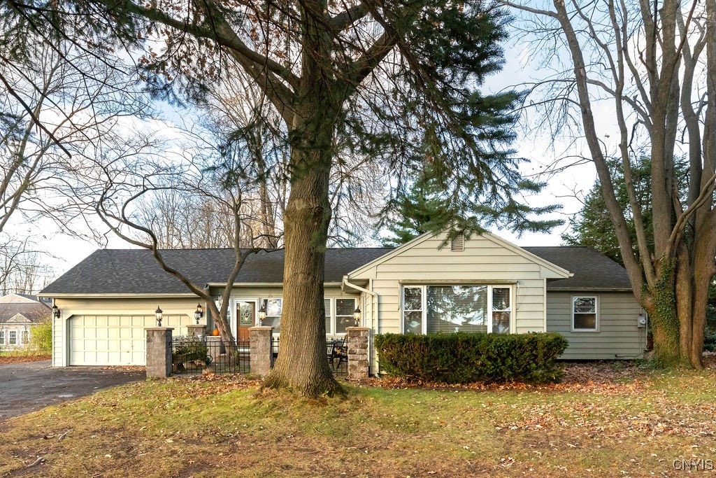 ranch-style home with a front yard and a garage