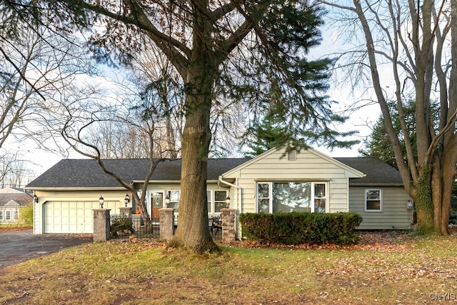 ranch-style home with a front yard and a garage