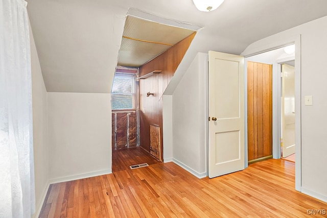 additional living space with lofted ceiling and light wood-type flooring