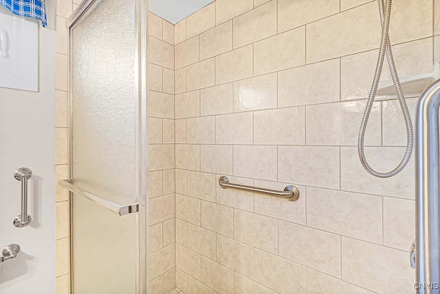 bathroom featuring a shower with door