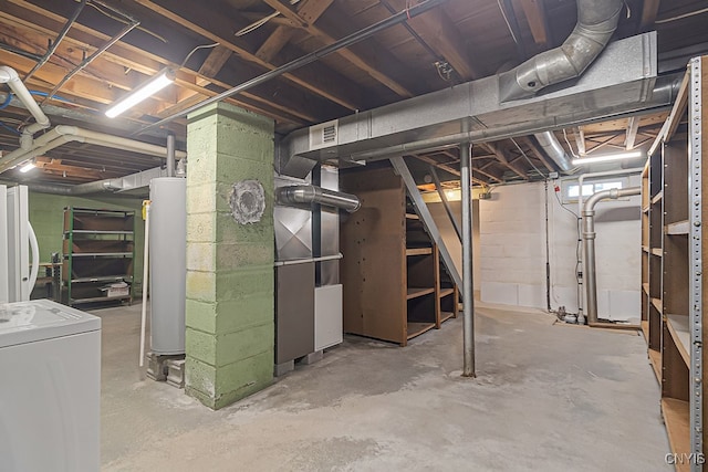 basement with white refrigerator, washer / clothes dryer, and water heater