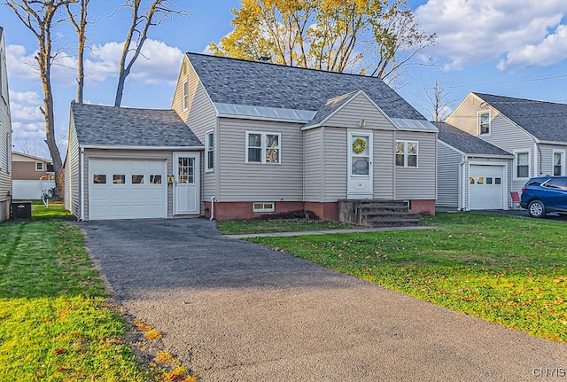 view of front of house with a front lawn and a garage