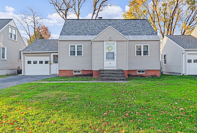 view of front facade with central AC unit, a garage, and a front lawn