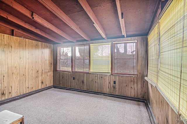 unfurnished sunroom featuring vaulted ceiling with beams