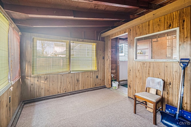 sitting room featuring vaulted ceiling with beams, wooden walls, light colored carpet, and wooden ceiling