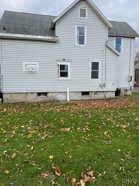 rear view of house with a yard