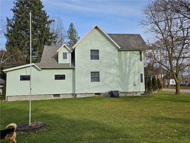 view of side of property with a lawn and cooling unit