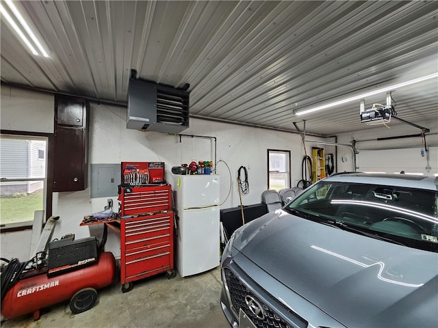 garage with white fridge and a garage door opener