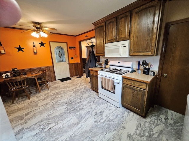 kitchen featuring white appliances, tasteful backsplash, ceiling fan, and crown molding