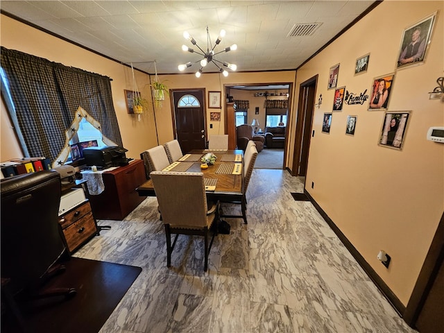 dining room with a chandelier and ornamental molding