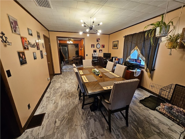 dining space featuring ceiling fan with notable chandelier and ornamental molding