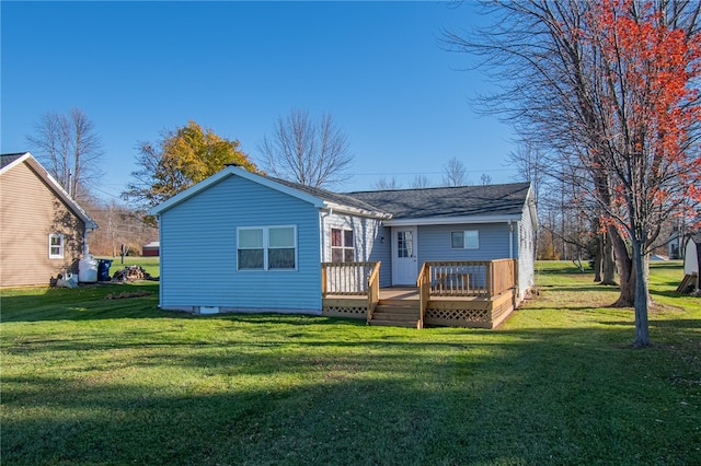 rear view of house featuring a yard and a wooden deck