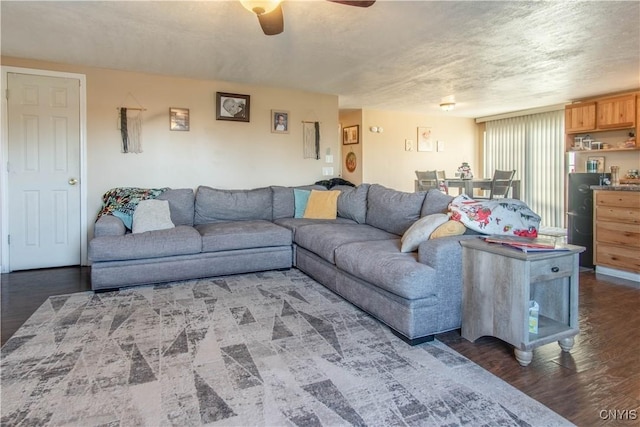 living room with dark hardwood / wood-style flooring and ceiling fan