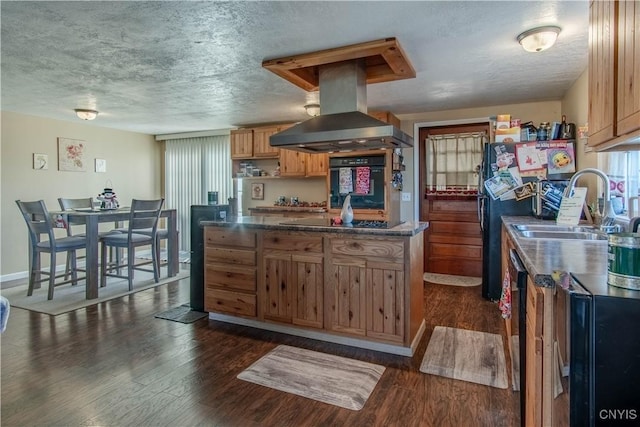 kitchen featuring a textured ceiling, island range hood, dark wood-type flooring, and black appliances