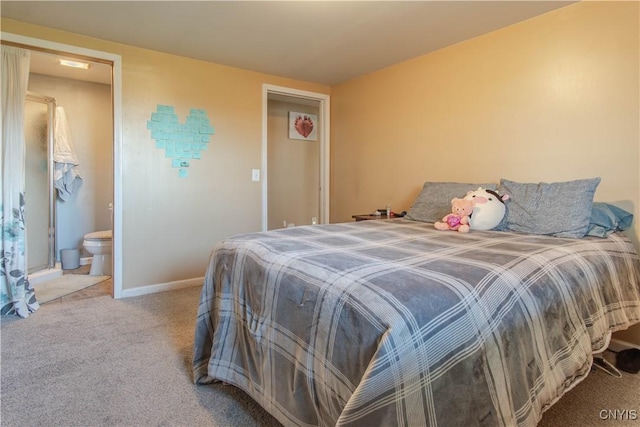 bedroom with connected bathroom and light carpet