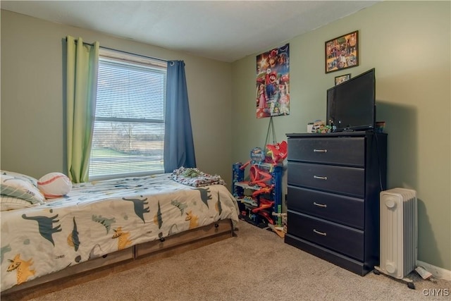 carpeted bedroom featuring radiator and multiple windows