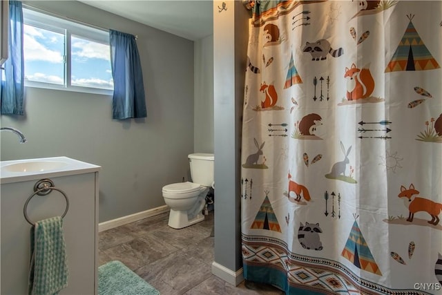 bathroom featuring vanity, a shower with shower curtain, and toilet