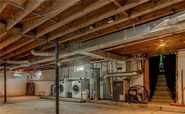 basement with washing machine and dryer and electric water heater