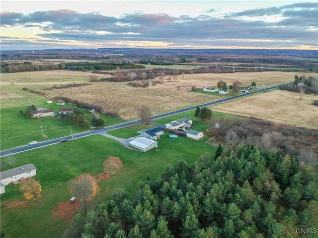 aerial view at dusk featuring a rural view