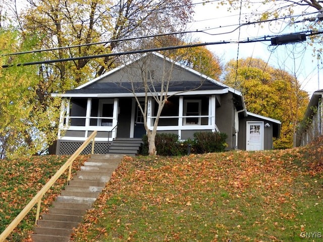 bungalow-style home featuring a porch and a garage