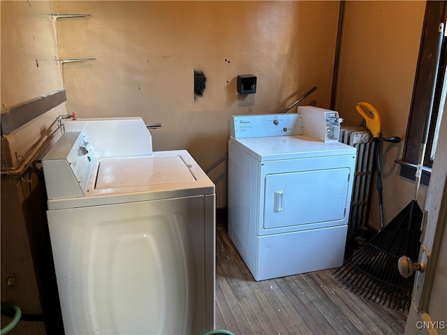 laundry room with washer and clothes dryer and wood-type flooring