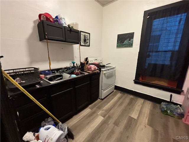 kitchen featuring white electric range oven and hardwood / wood-style floors