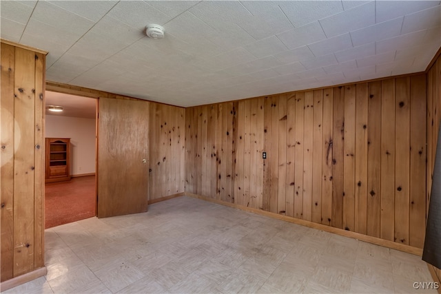 unfurnished room with wooden walls