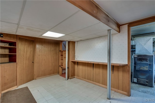 basement featuring wood walls