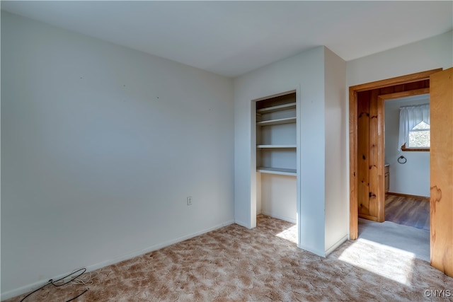 unfurnished bedroom with light colored carpet