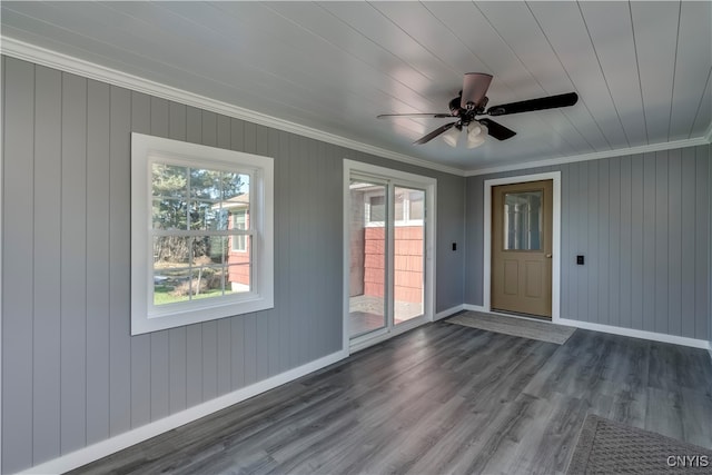 spare room with ornamental molding, ceiling fan, and dark hardwood / wood-style flooring