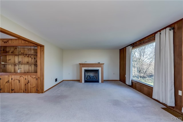 unfurnished living room featuring light carpet