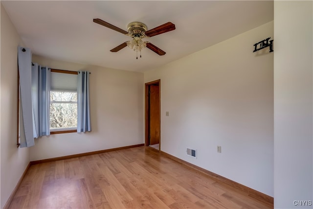 spare room featuring light hardwood / wood-style floors and ceiling fan