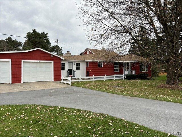 ranch-style home with a front yard and a garage