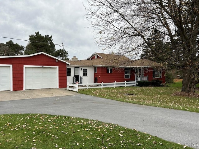 ranch-style house with a chimney, a garage, a front lawn, and fence private yard