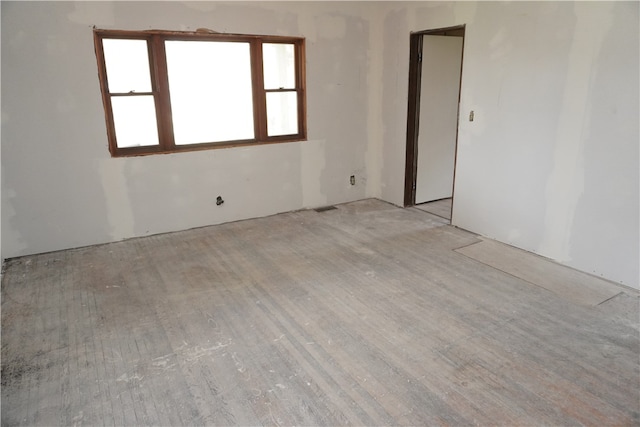 unfurnished room with light wood-type flooring