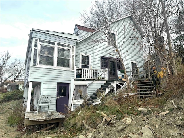 back of house with a wooden deck