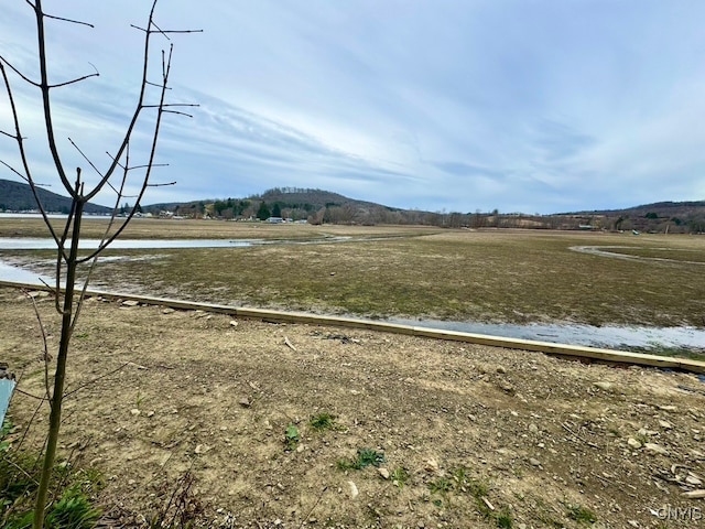 exterior space with a rural view and a water view