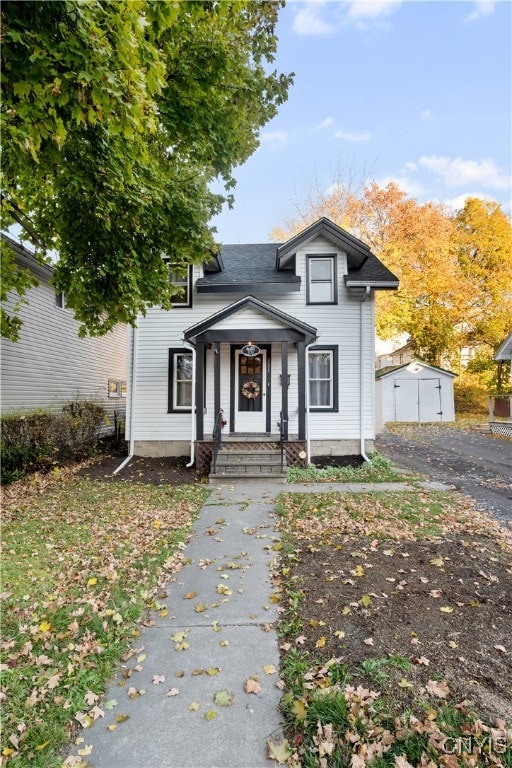 front of property with a garage and an outdoor structure