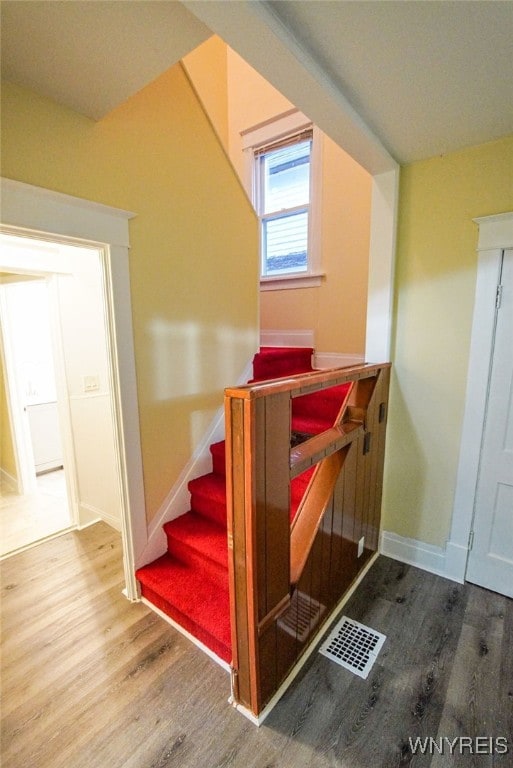 stairway featuring wood-type flooring