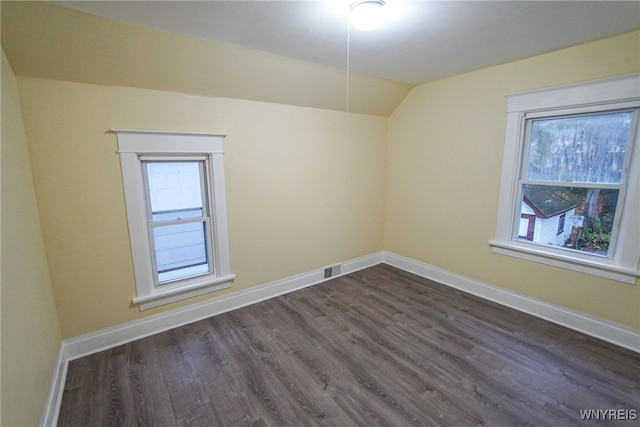 bonus room featuring dark hardwood / wood-style floors and vaulted ceiling