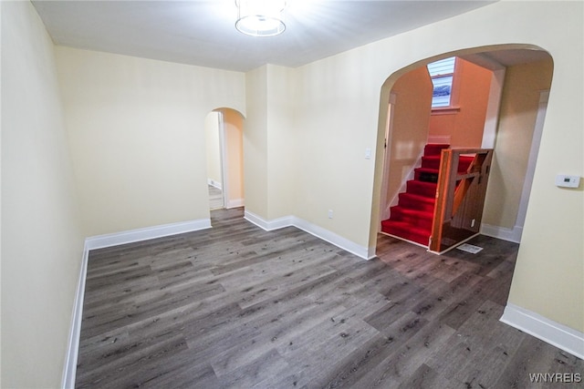 unfurnished room featuring dark wood-type flooring