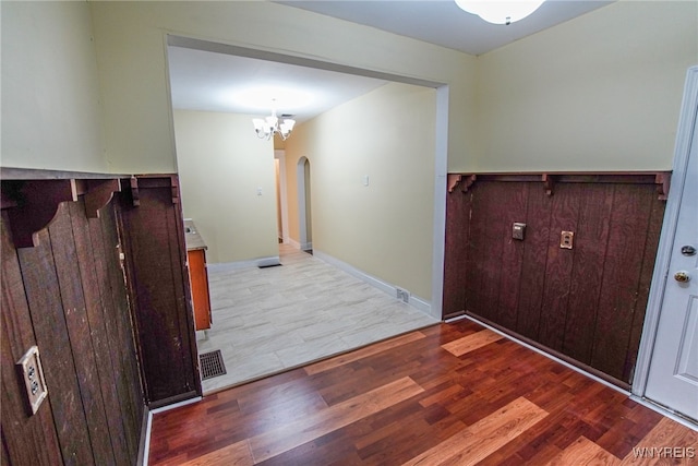 entrance foyer with wood-type flooring and a chandelier