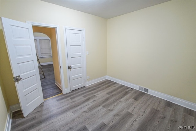 spare room featuring wood-type flooring