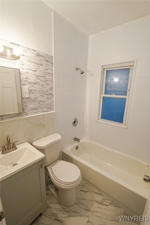 full bathroom with vanity, shower / bathing tub combination, tile walls, and toilet