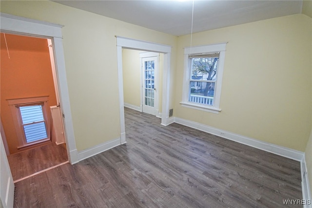 unfurnished room with dark wood-type flooring