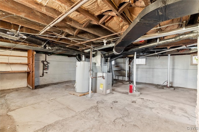 basement with heating unit, a wealth of natural light, and gas water heater