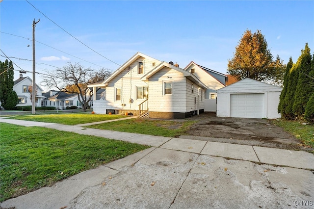 view of front facade with a front yard, an outbuilding, and a garage