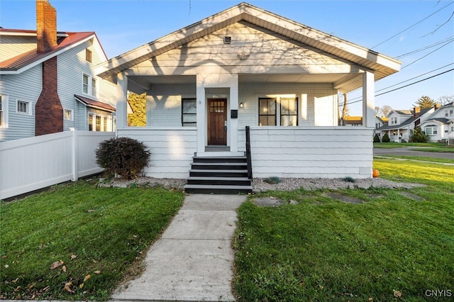 bungalow-style home featuring a porch and a front lawn